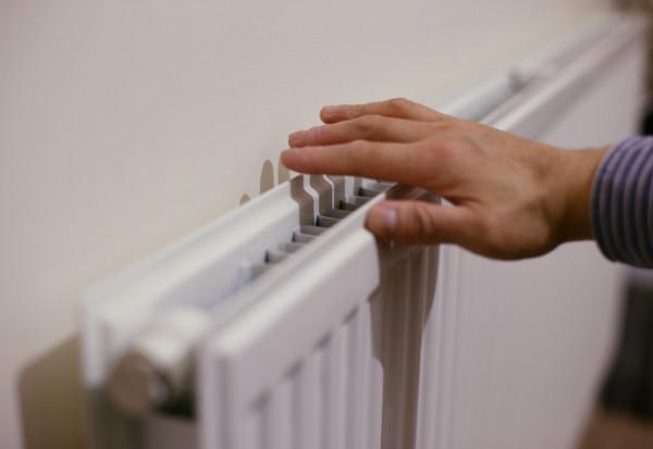 hand on radiator check hand on radiator checking heat output.