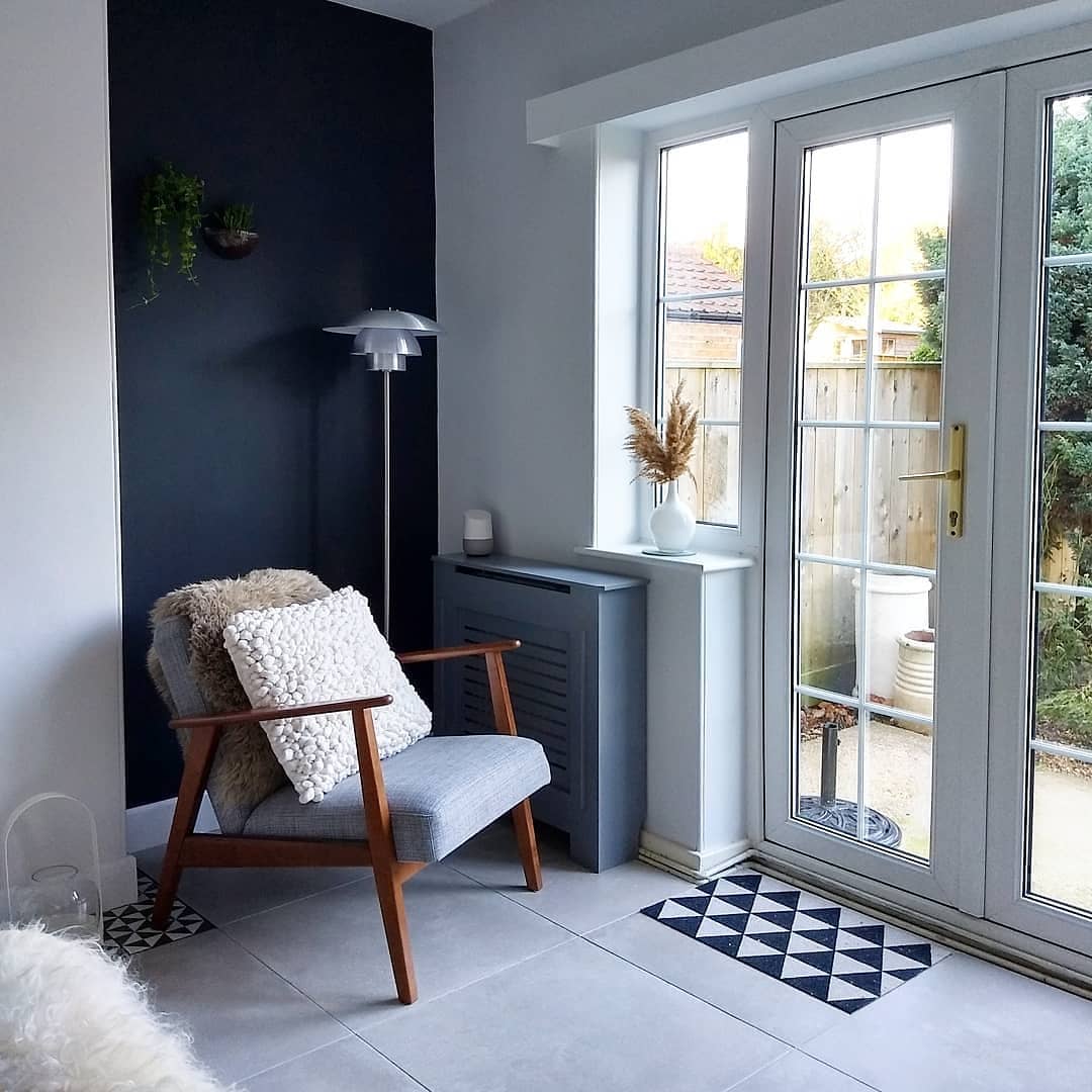 49858192_380315915852199_7338993005497427820_n A grey armchair in a Scandinavian style living room.
