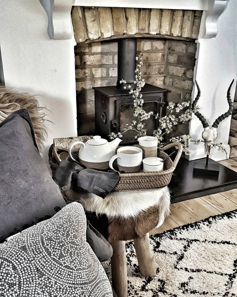 56544819_2066771913620552_3923138851922623426_n A rustic living room with a cast-iron fireplace.